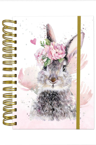 Notebook with a rabbit illustration wearing a flower crown on a pink background