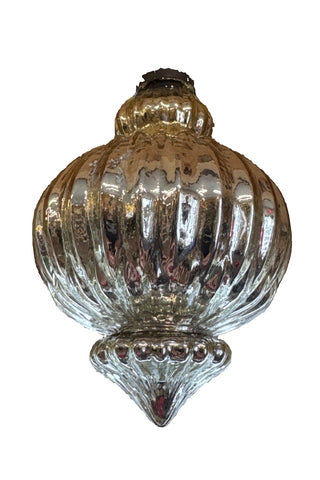 A golden ceiling-mounted chandelier with a spherical ornament and a tag hanging from it.