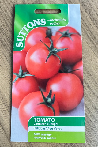 Suttons tomato seed packet on a wooden surface