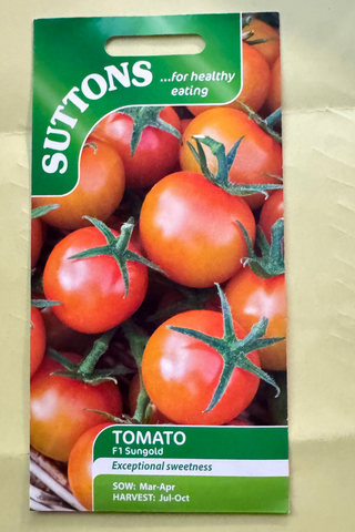 Suttons tomato seed packet with images of tomatoes on a beige background