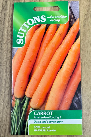 Suttons carrot seed packet on a wooden surface
