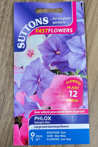 Suttons Phlox seed packet on a wooden surface