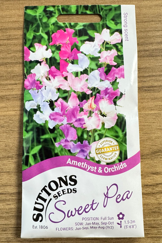Suttons Seeds Sweet Pea packaging with flowers on a wooden surface