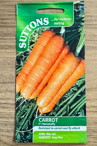Suttons carrot seed packet on a wooden surface