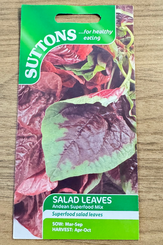 Suttons salad leaves seed packet on a wooden surface