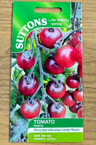Suttons tomato seed packet on a wooden surface