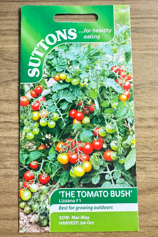 Suttons tomato seed packet on a wooden surface