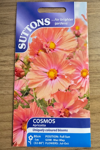 Suttons cosmos apricotta seed packet on a wooden surface