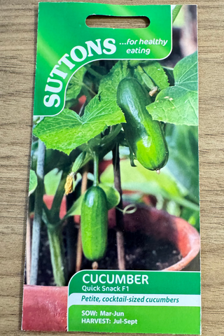Suttons cucumber seed packet on a wooden surface