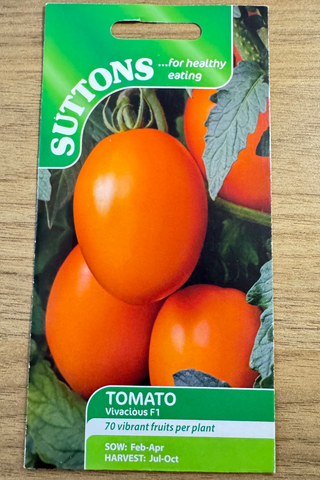 Suttons tomato seed packet on a wooden surface