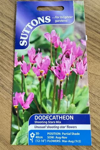 Suttons dodecatheon seed packet on a wooden surface