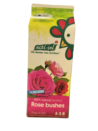 A carton of ActiSol Rose Bushes fertilizer with a picture of a rose and a chicken on the packaging, indicating it is a natural fertilizer for rose bushes.