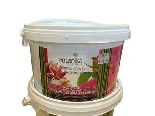 A white plastic bucket of Botanika brand soluble fertilizer for flowering plants, with a label featuring colorful flowers and the price of $15.95.