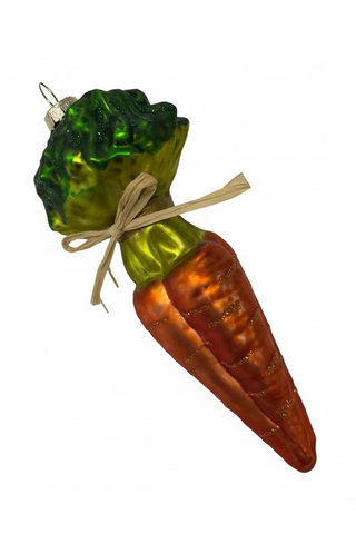 Decorative glass ornament shaped like a carrot with a green top on a white background
