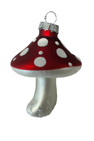 Glass mushroom ornament with red cap and white spots on a white background