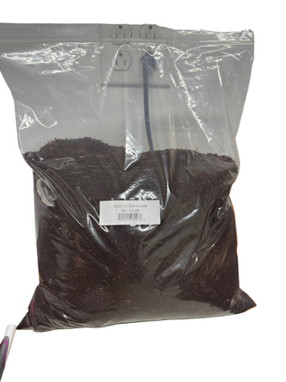 A plastic bag containing loose brown coco coir, with a label showing barcode and weight information.
