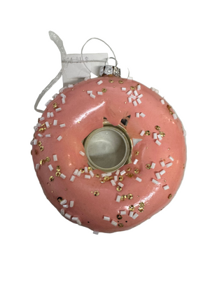 A pink glazed donut ornament with glitter and a metallic finish, designed for seasonal decoration.