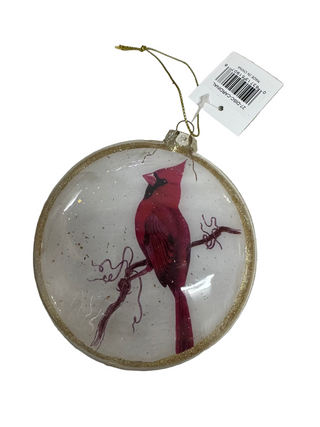 A round, multicolored Christmas ornament featuring a red bird with a golden halo and red and green details on a clear background, hanging from a gold ribbon.