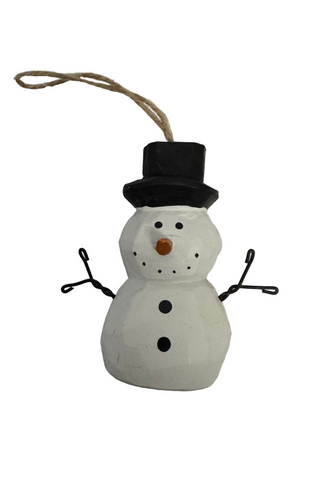 A plastic Christmas ornament depicting a snowman with a hat, hanging from a tag.