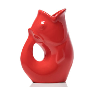 Red ceramic fish-shaped pitcher on a white background. It makes gurgling sounds when you pour water.