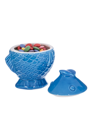 Blue fish-shaped candy bowl with colorful candies on a white background
