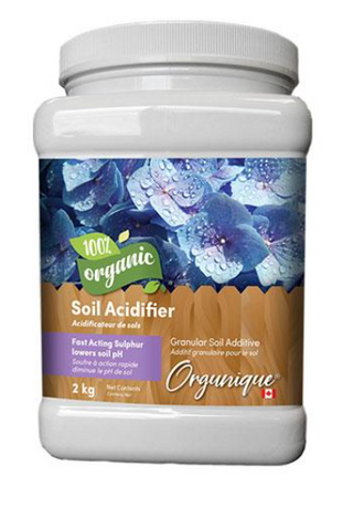 A container of Orgunique Soil Acidifier with a label showing blueberries and granular fertilizer.