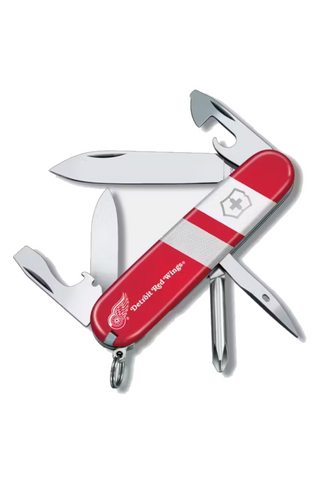 Red Swiss Army knife with multiple tools on a white background