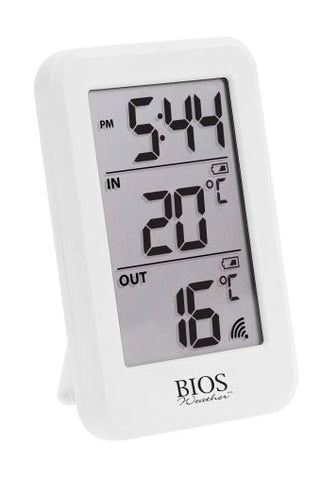 Digital clock and thermometer with a separate sensor on a white background