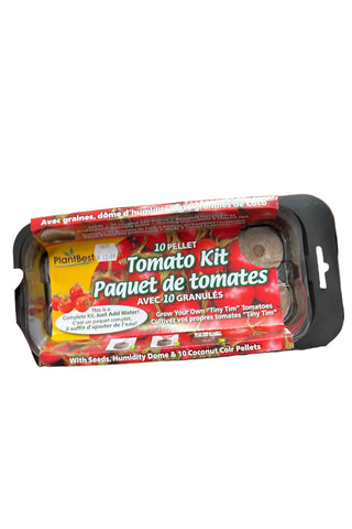 A hand is holding a tomato kit package which includes a pot with soil and a seed tray, labeled for indoor or outdoor gardening.